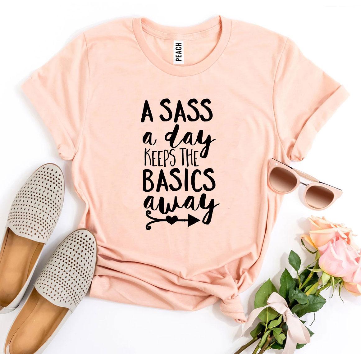 A stylish black t-shirt featuring the phrase 'A Sass a Day Keeps The Basics Away' printed in a high-quality design.