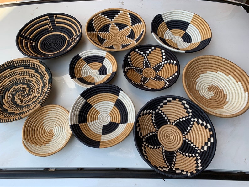 A vibrant set of 10 African wall baskets made from sisal grass, showcasing unique patterns and colors, perfect for home decor.