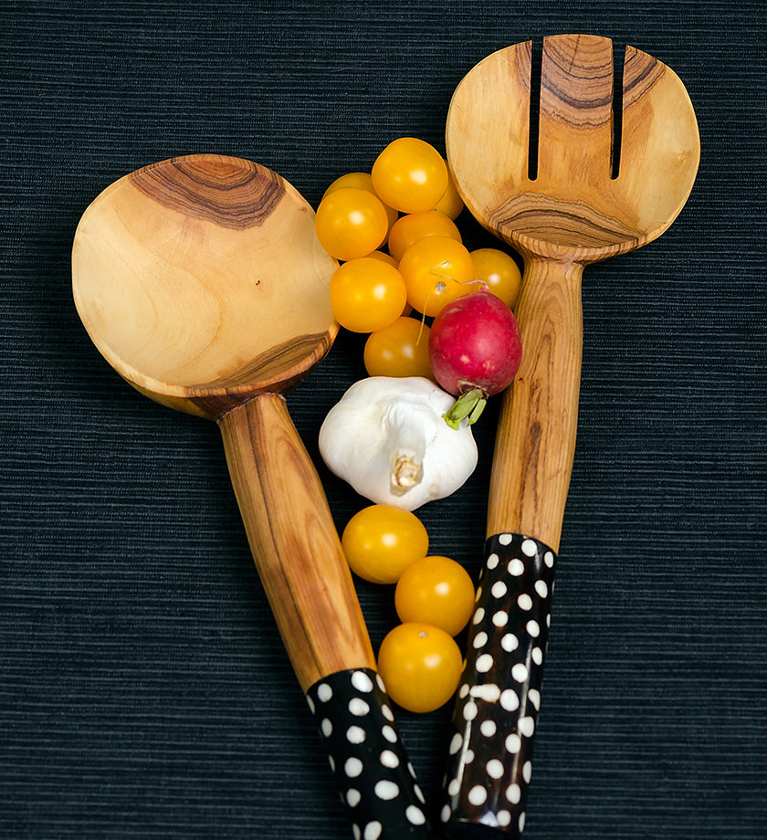 African olive wood salad servers with dotted batik handles, showcasing unique craftsmanship and sustainable materials.