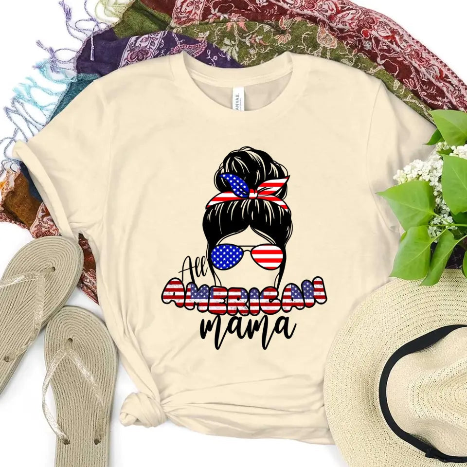 All American Mama 4th Of July Mom T-shirt featuring bold patriotic graphics on a soft ringspun cotton fabric.