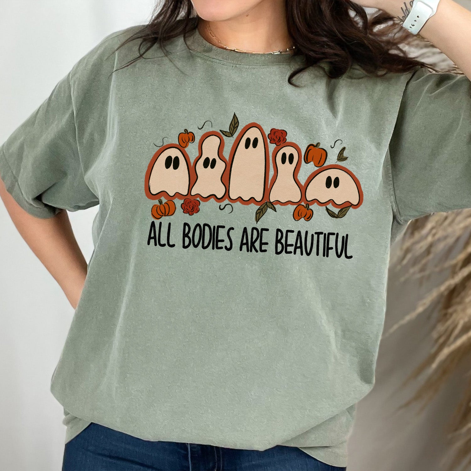 All Bodies Are Beautiful Ghosts Unisex T-shirt displayed on a neutral background, showcasing its vibrant design and soft fabric.