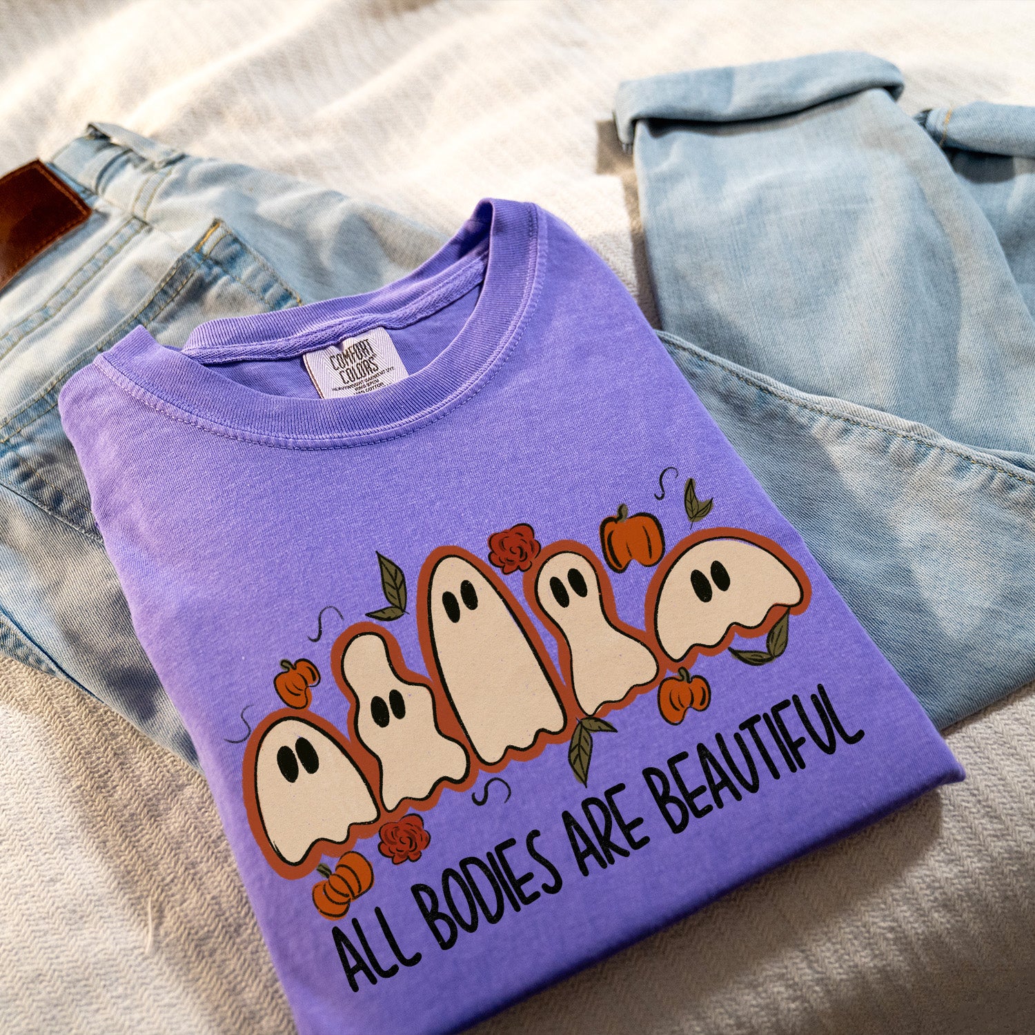 All Bodies Are Beautiful Ghosts Unisex T-shirt displayed on a neutral background, showcasing its vibrant design and soft fabric.
