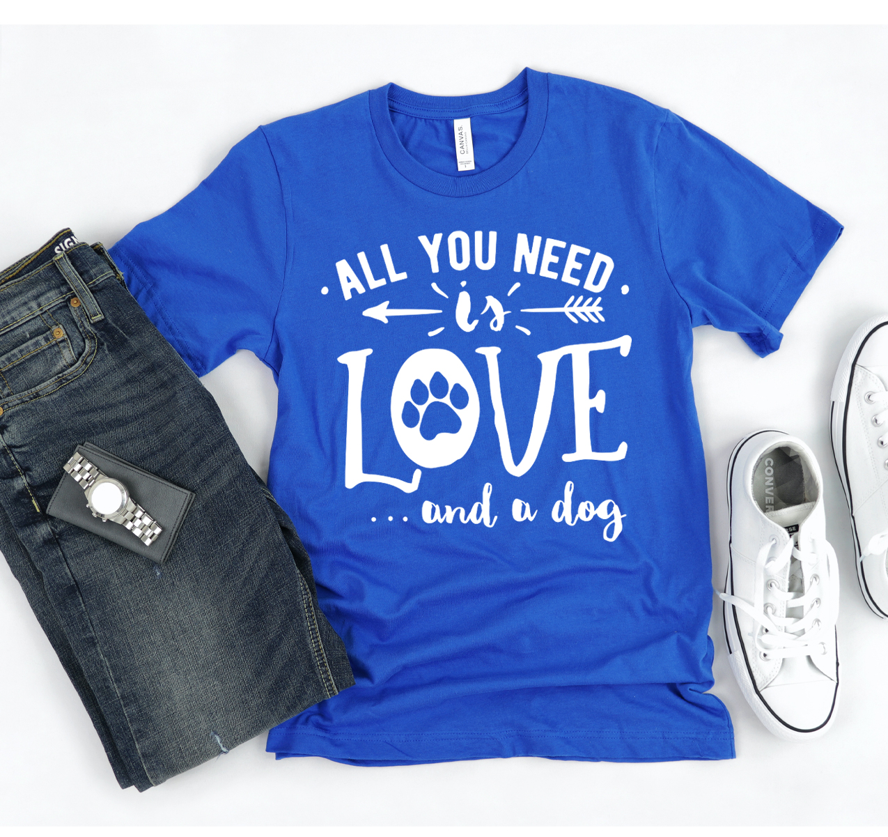 A stylish unisex t-shirt featuring the phrase 'All You Need Is Love And A Dog', made from soft cotton fabric.
