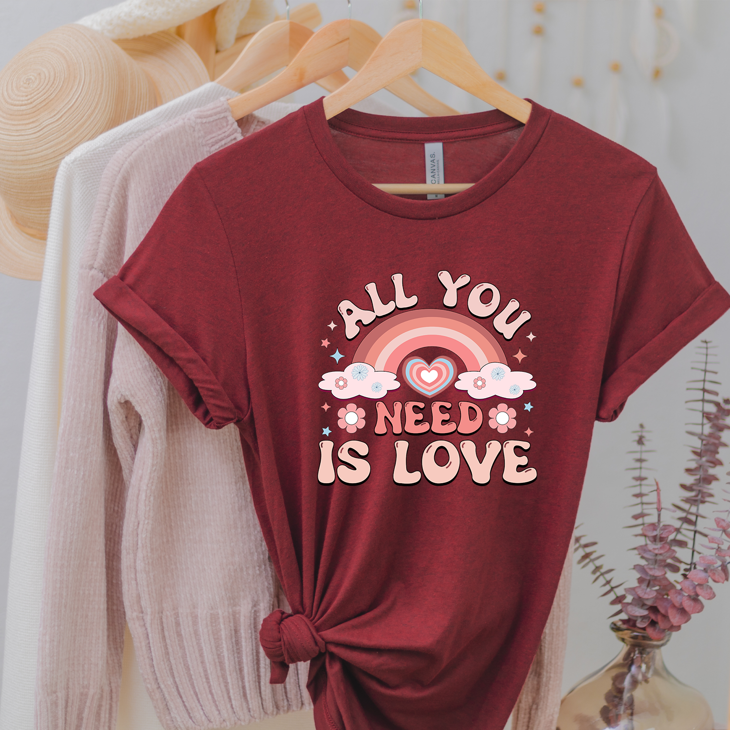 All You Need is Love Rainbow Unisex T-shirt featuring a colorful rainbow design on a soft fabric.