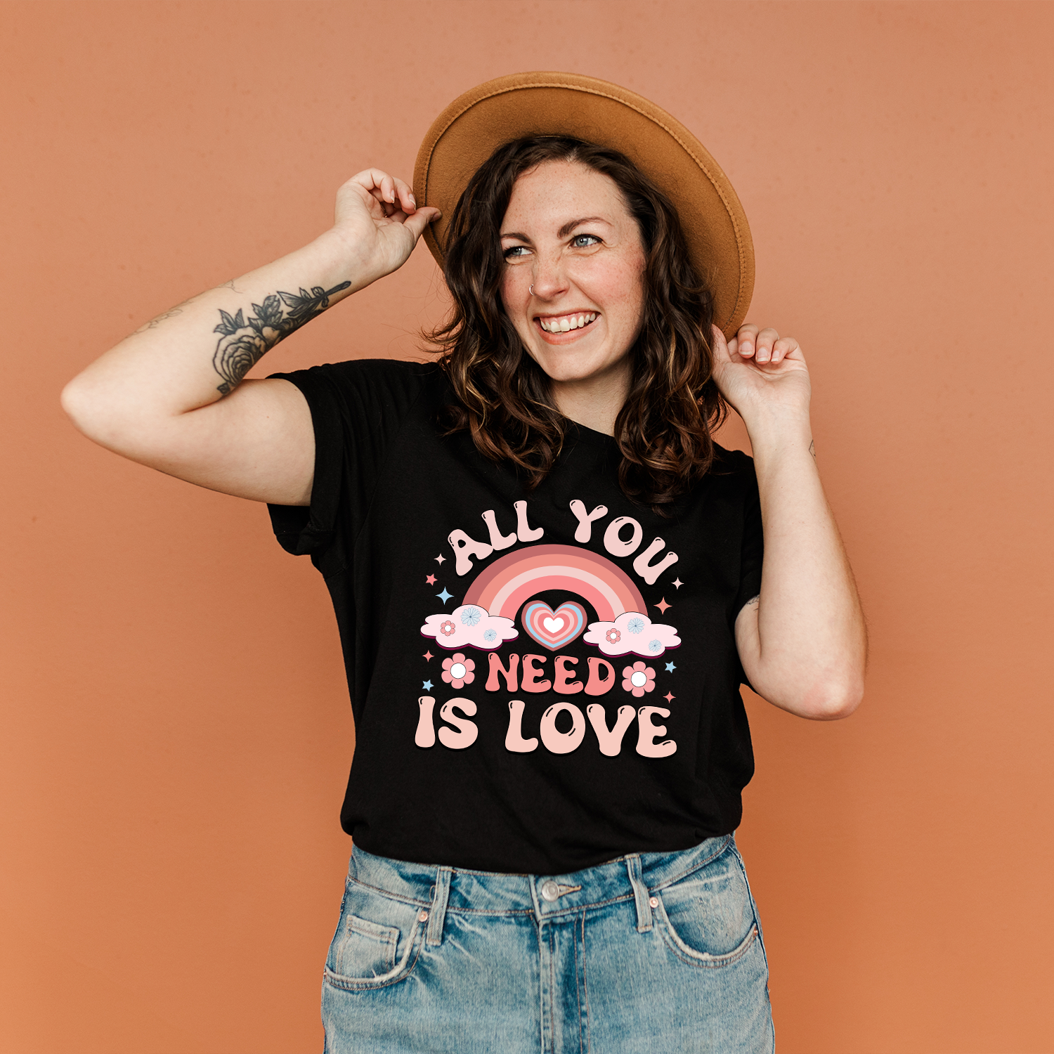 All You Need is Love Rainbow Unisex T-shirt featuring a colorful rainbow design on a soft fabric.