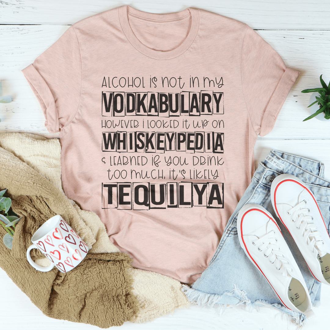 A stylish black tee shirt featuring the phrase 'Alcohol Is Not In My Vodkabulary' in bold, artistic lettering, made from 100% Ring-Spun Cotton.