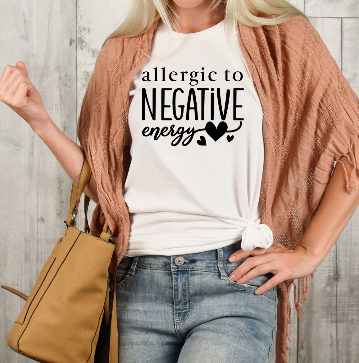A stylish unisex t-shirt featuring the phrase 'Allergic To Negative Energy' printed in vibrant colors, showcasing a modern design.