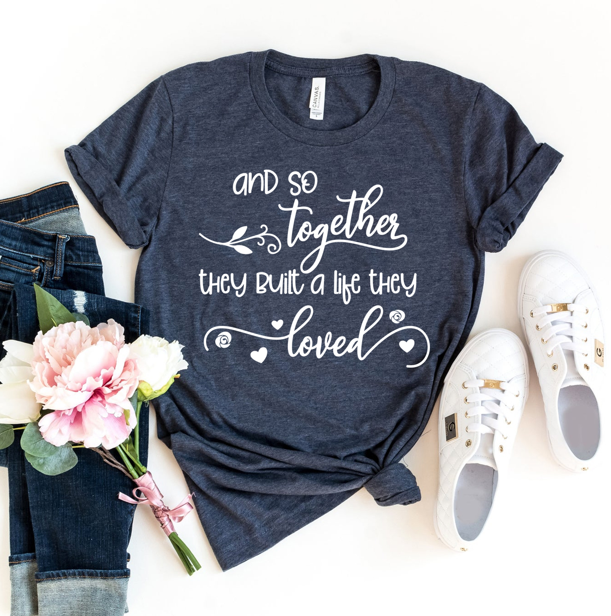 A stylish T-shirt featuring the phrase 'And So Together They Built A Life They Loved', made from premium ring spun cotton with a soft feel.