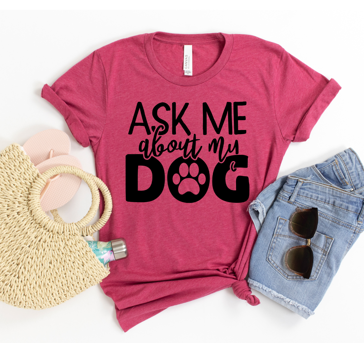 A stylish Ask Me About My Dog t-shirt displayed on a hanger, showcasing its soft fabric and vibrant print.
