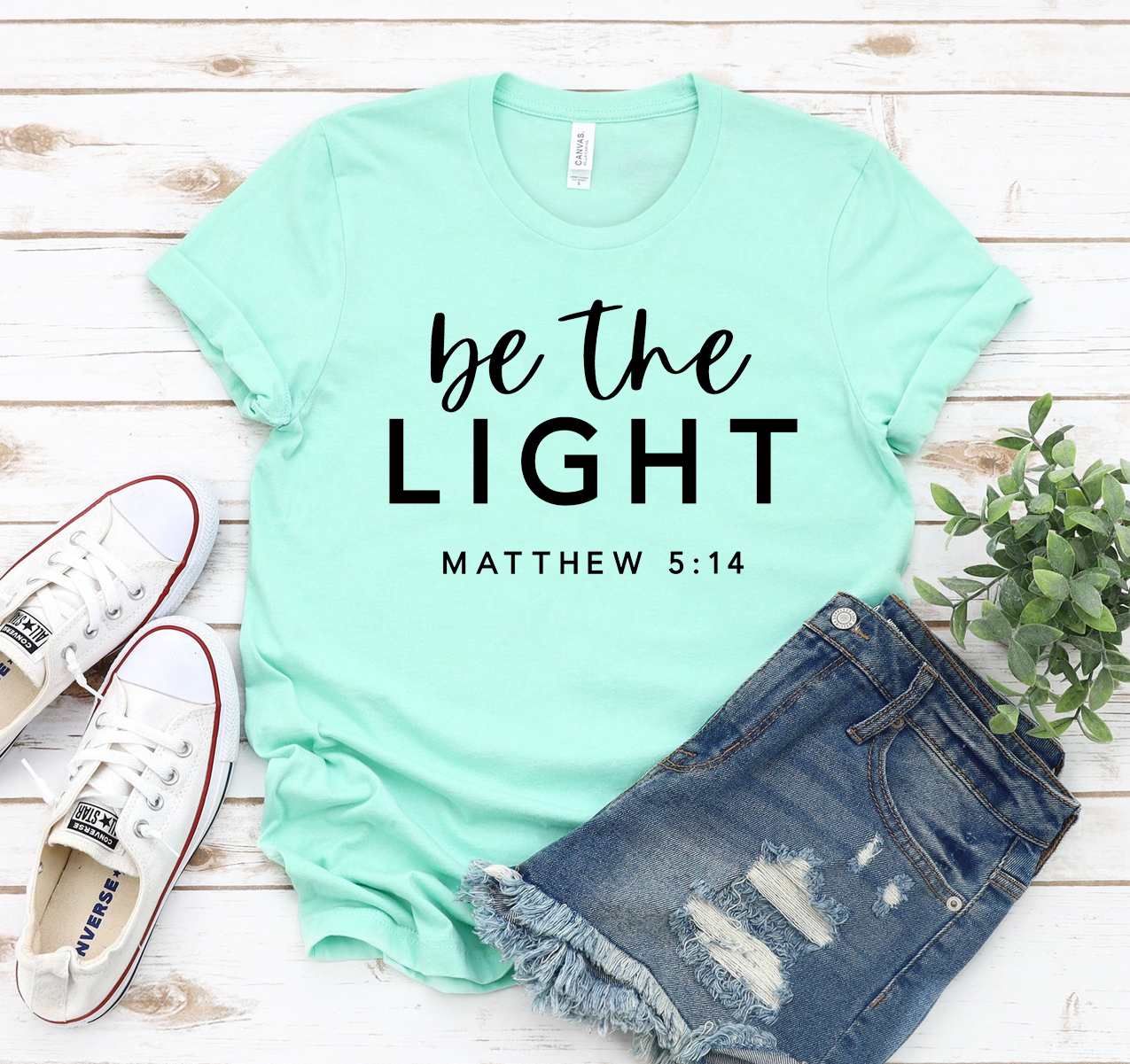 Be The Light T-shirt in various sizes, showcasing its soft fabric and classic unisex design.