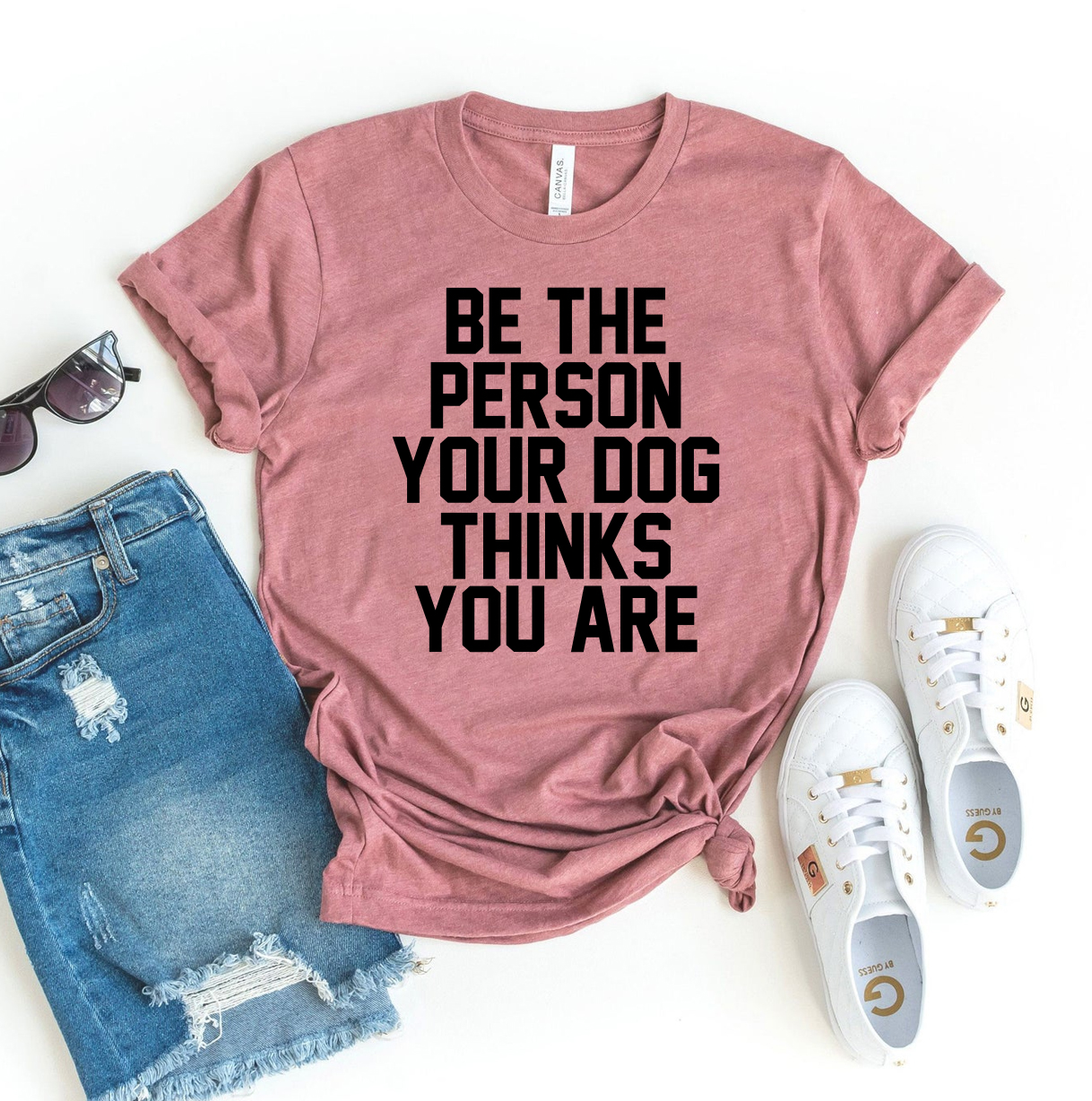 A soft, comfortable t-shirt featuring the phrase 'Be The Person Your Dog Thinks You Are', made from premium ring spun cotton.