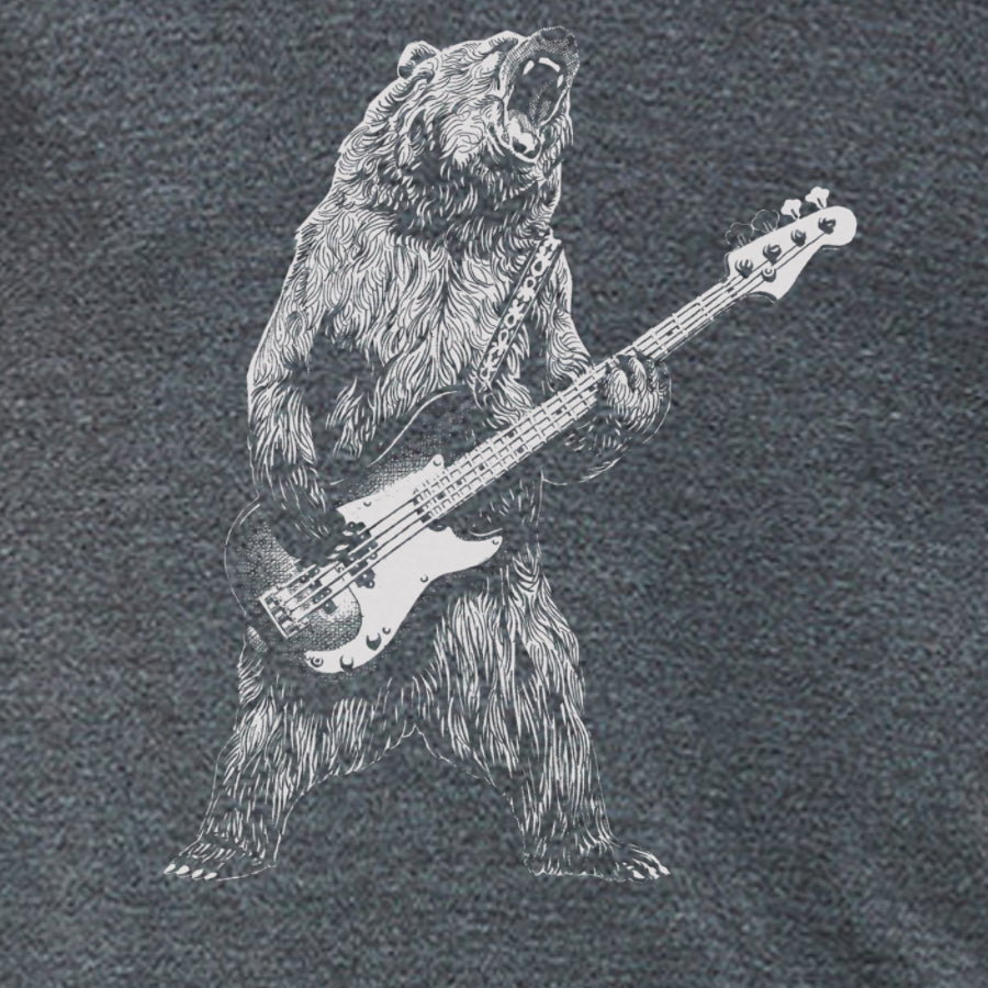 A playful bear playing a bass guitar on a soft t-shirt, showcasing eco-friendly printing.