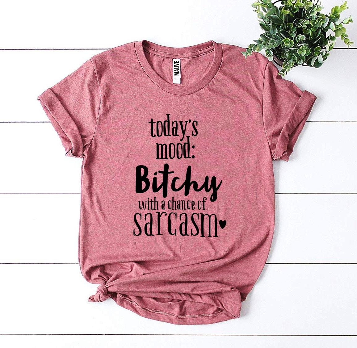 Bitchy With a Chance Of Sarcasm T-shirt displayed on a hanger, showcasing its soft cotton fabric and witty design.