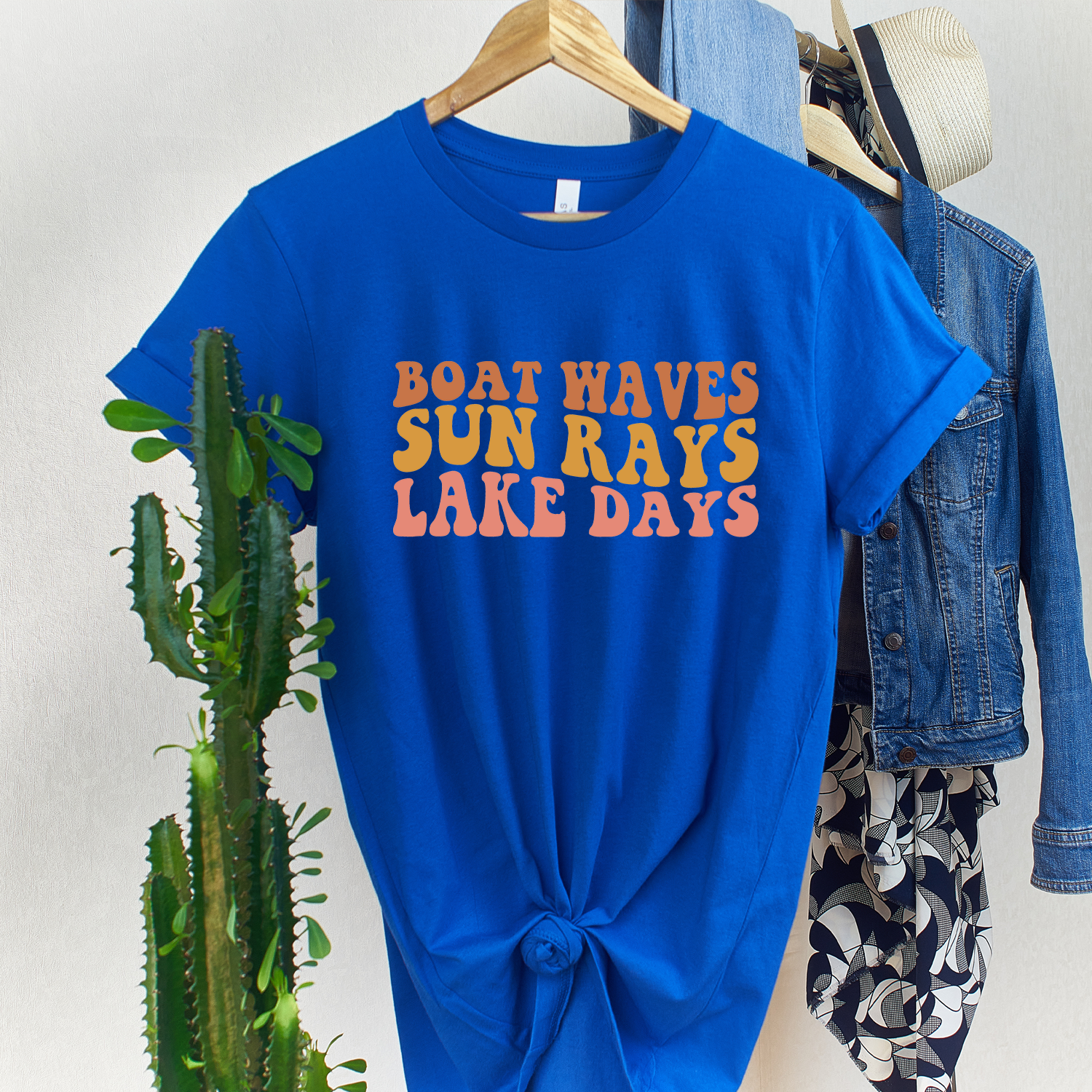 Boat Waves Sun Rays Unisex T-shirt featuring vibrant ocean-inspired design, perfect for beach lovers.