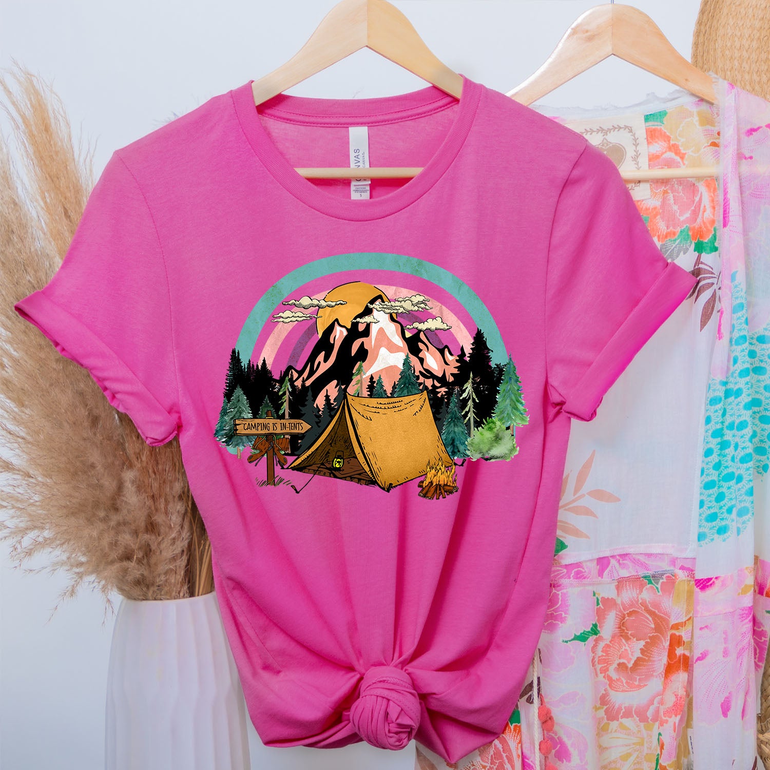 A stylish unisex t-shirt featuring the phrase 'Camping Is in Tents', perfect for outdoor enthusiasts.