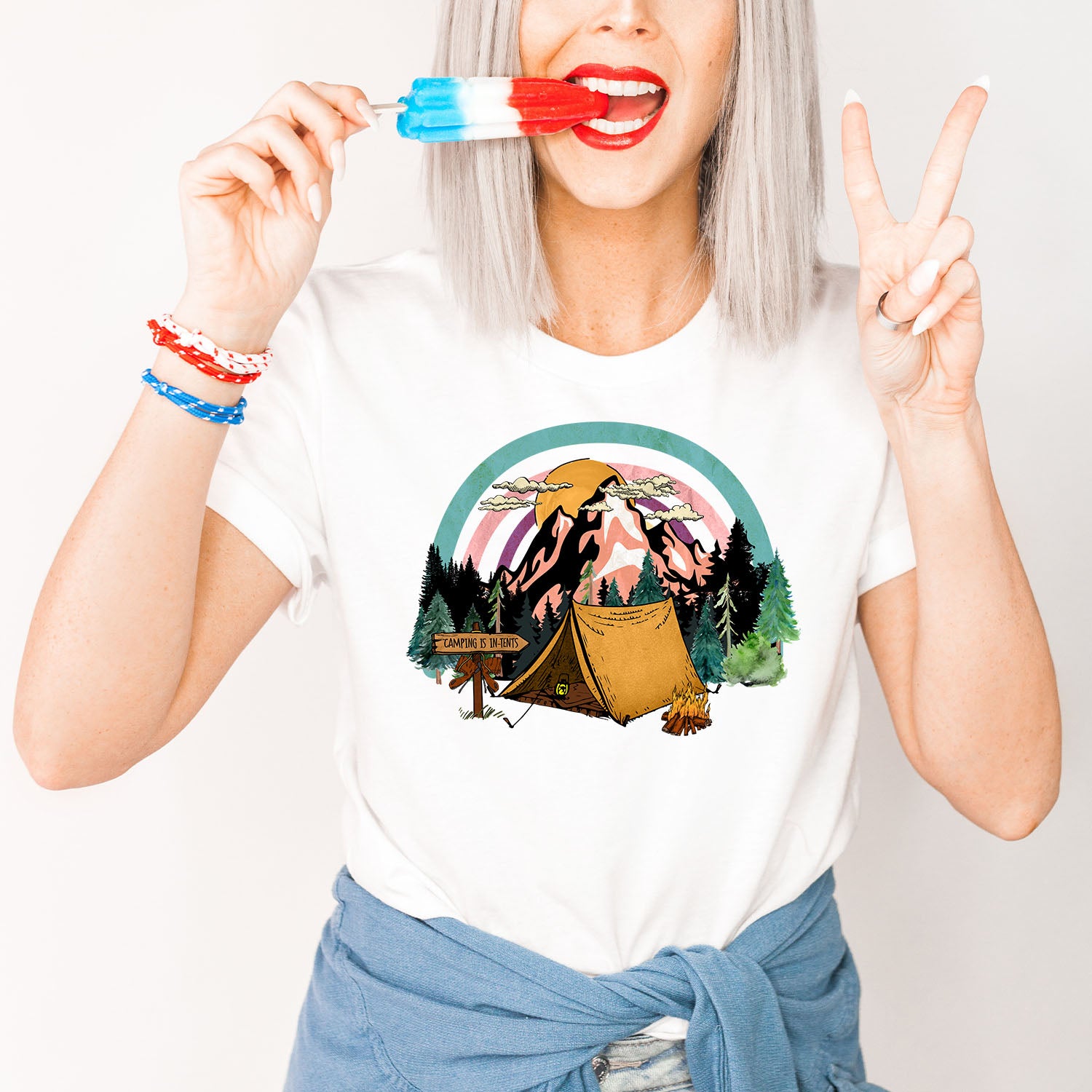 A stylish unisex t-shirt featuring the phrase 'Camping Is in Tents', perfect for outdoor enthusiasts.