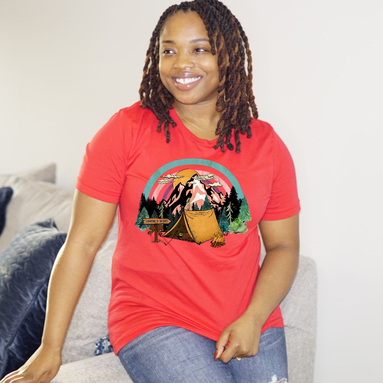 A stylish unisex t-shirt featuring the phrase 'Camping Is in Tents', perfect for outdoor enthusiasts.