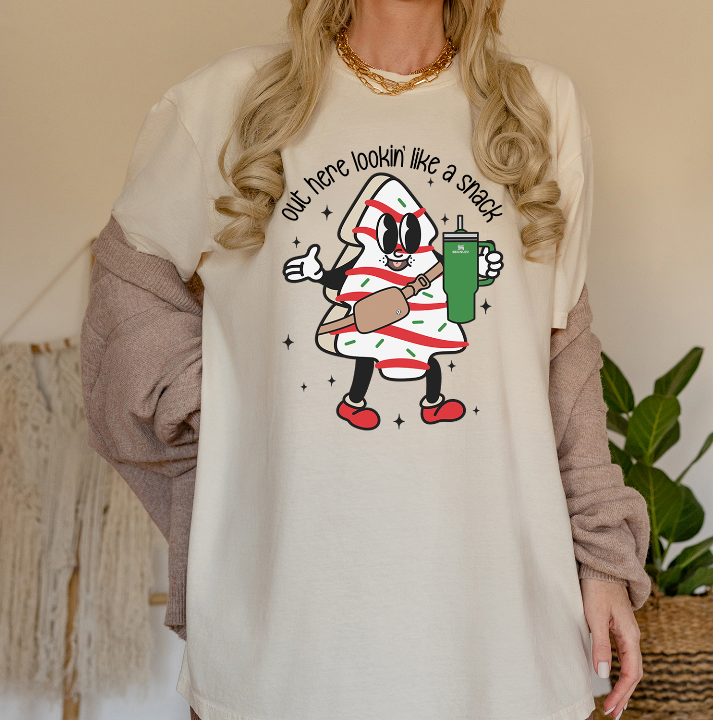 A festive unisex T-shirt featuring the phrase 'Christmas Lookin Like a Snack' printed in vibrant colors on a soft fabric.