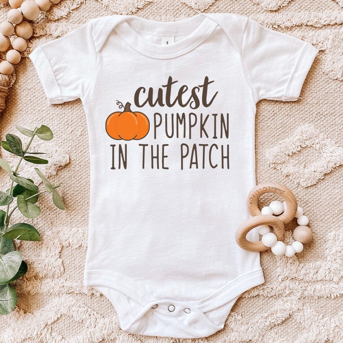 Adorable baby wearing the Cutest Pumpkin In The Patch! Baby Onesie, showcasing its cute design and vibrant colors.