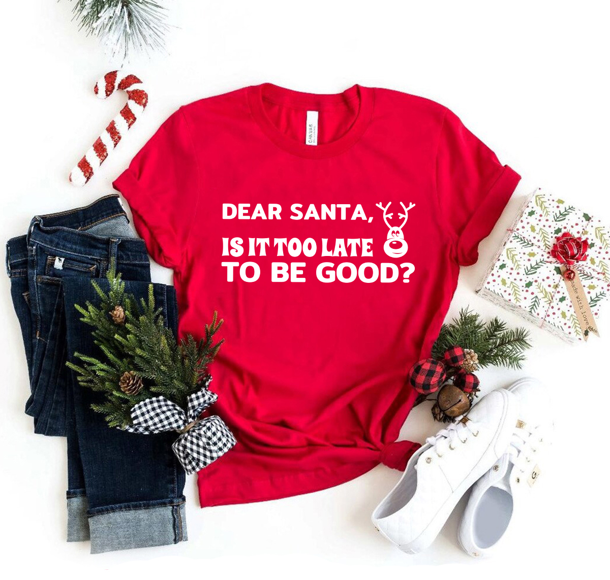 A festive unisex T-shirt featuring the phrase 'Dear Santa Is It Too Late To Be Good' in a playful font, available in multiple colors.