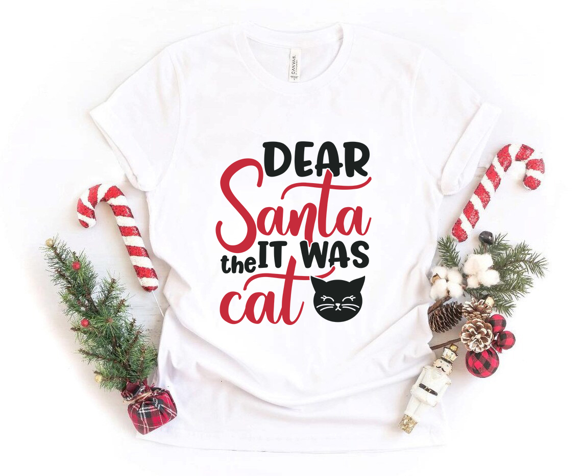 A unisex T-shirt featuring the playful text 'Dear Santa It Was The Cat' in a festive design, made from soft ring spun cotton.