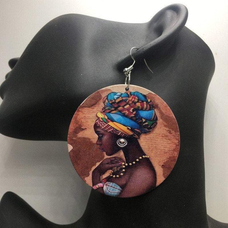 A pair of handcrafted round wooden earrings with a dangle design, showcasing ethnic and traditional African jewelry style.