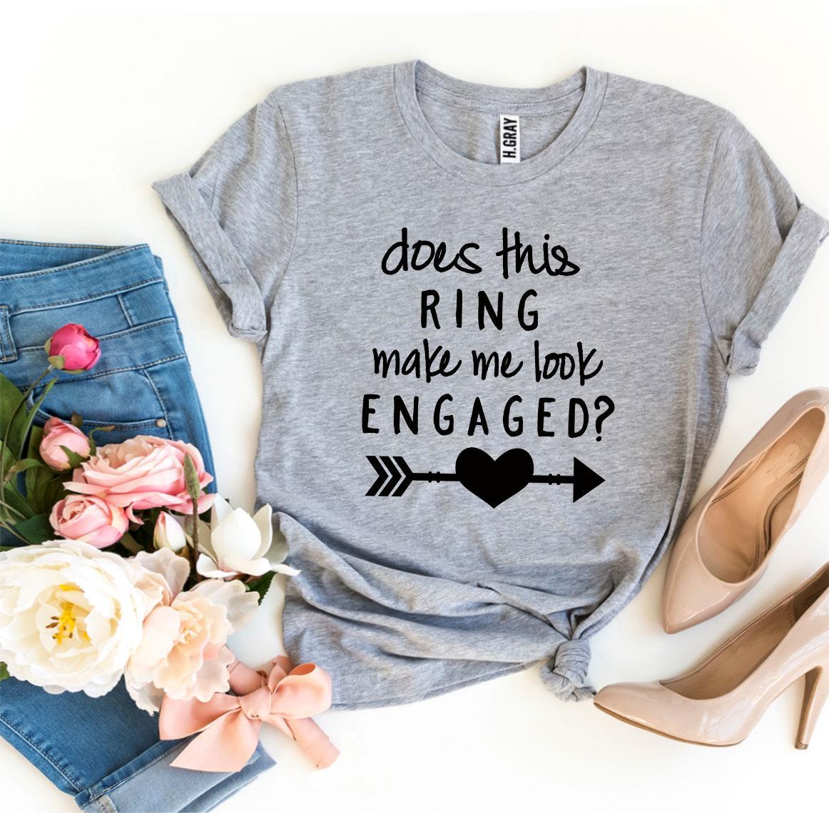 A stylish black T-shirt with the phrase 'Does This Ring Make Me Look Engaged?' printed in white, showcasing a humorous engagement theme.