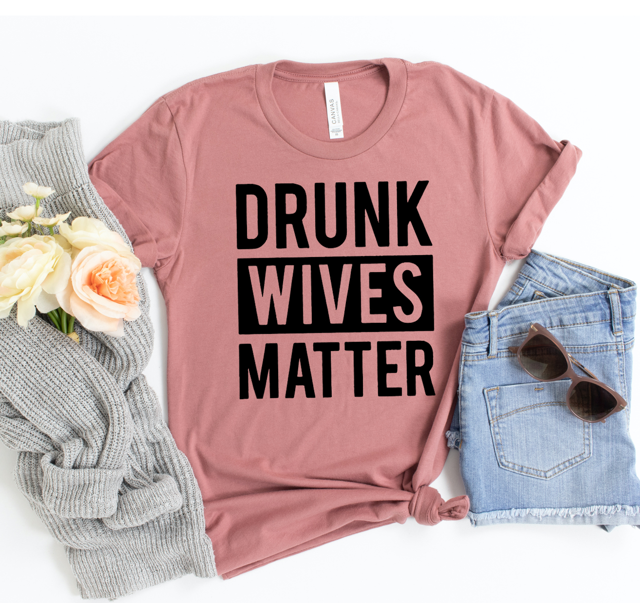 Drunk Wives Matter T-shirt displayed on a hanger, showcasing its unisex design and soft fabric.