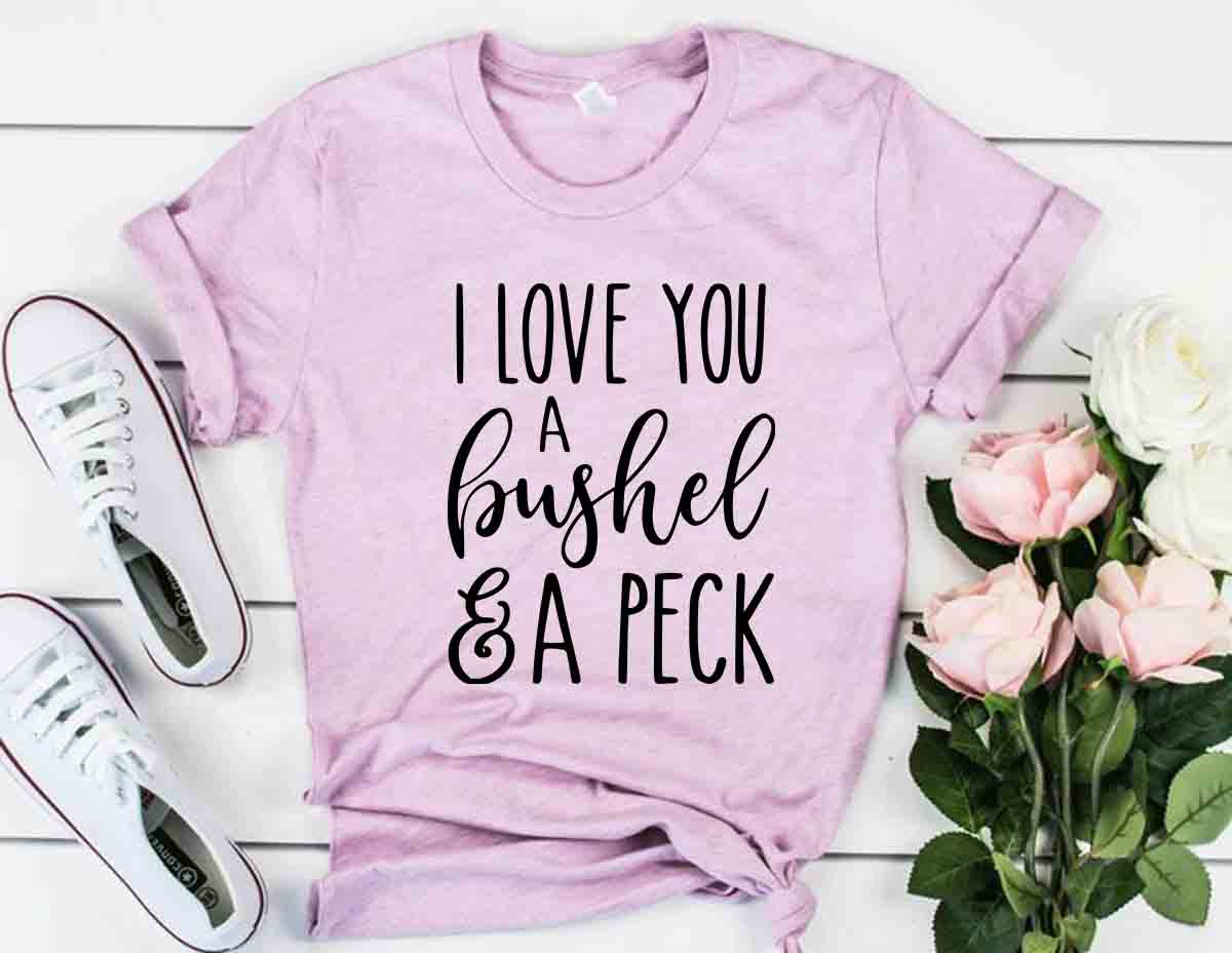 DT0231 I Love You A Bushel And A Perk Shirt displayed in multiple colors, showcasing its soft fabric and stylish design.
