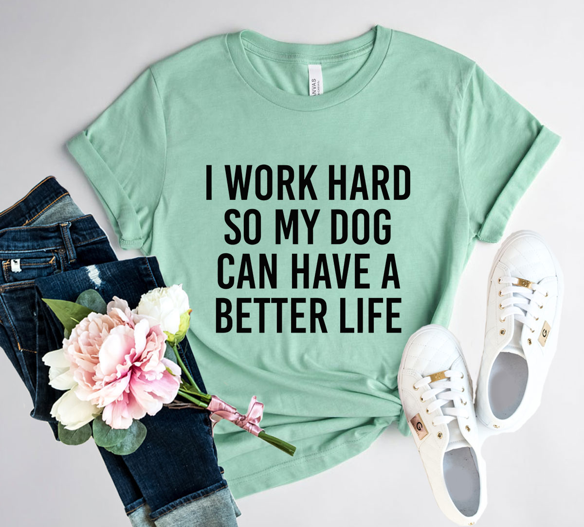 Unisex T-shirt featuring the phrase 'I Work Hard So My Dog Can Have A Better Life' in vibrant print, made from soft ring spun cotton.