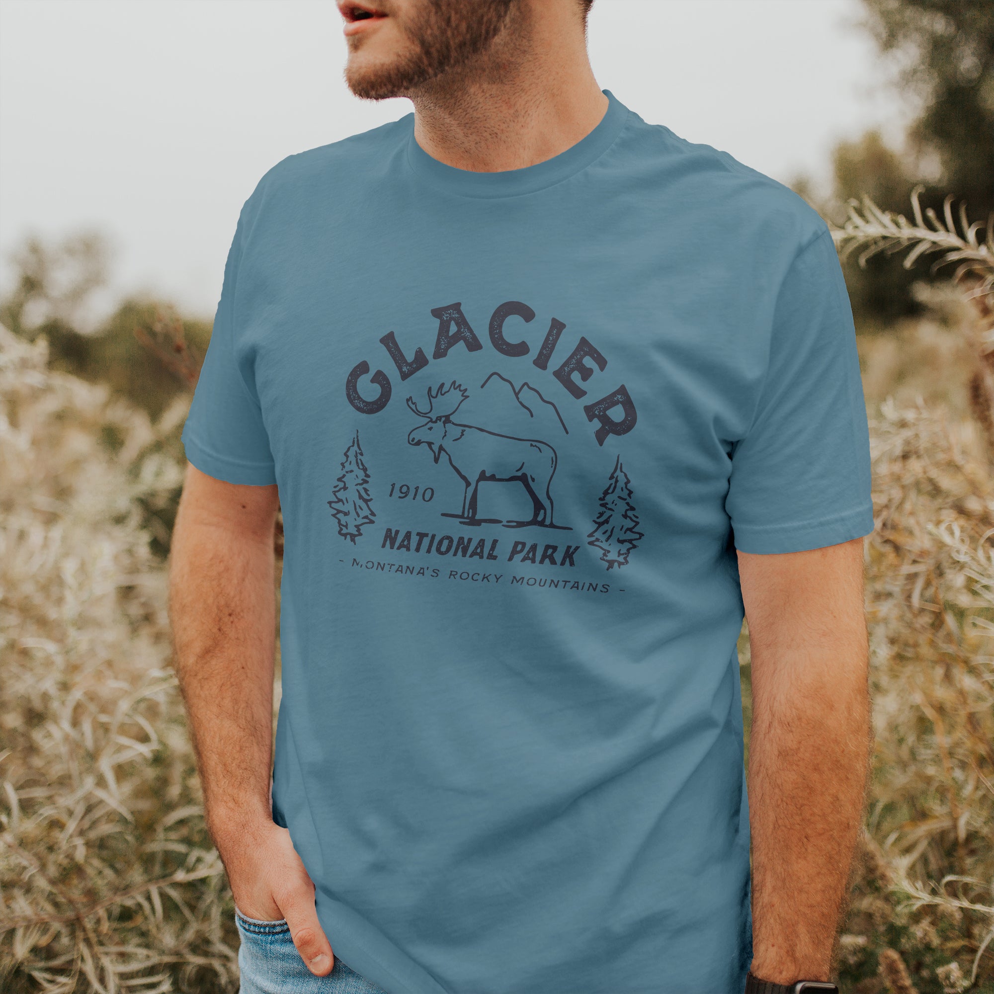 A soft, relaxed fit short sleeve t-shirt featuring a distressed design inspired by Glacier National Park, made from 100% combed cotton.