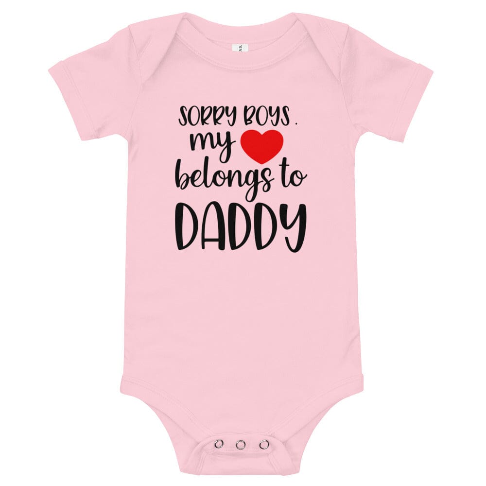 A cute baby wearing a Heart Belongs To Daddy Onesie, showcasing its soft fabric and playful design.