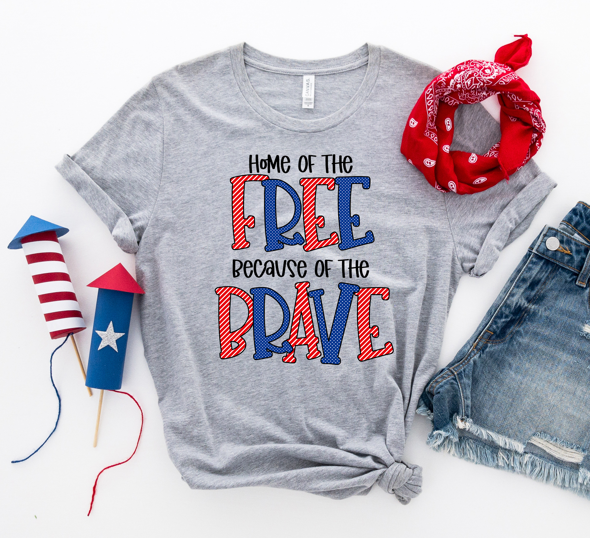 A patriotic T-shirt featuring the phrase 'Home of the Free Because of the Brave', made from soft ring spun cotton with a high-quality print.
