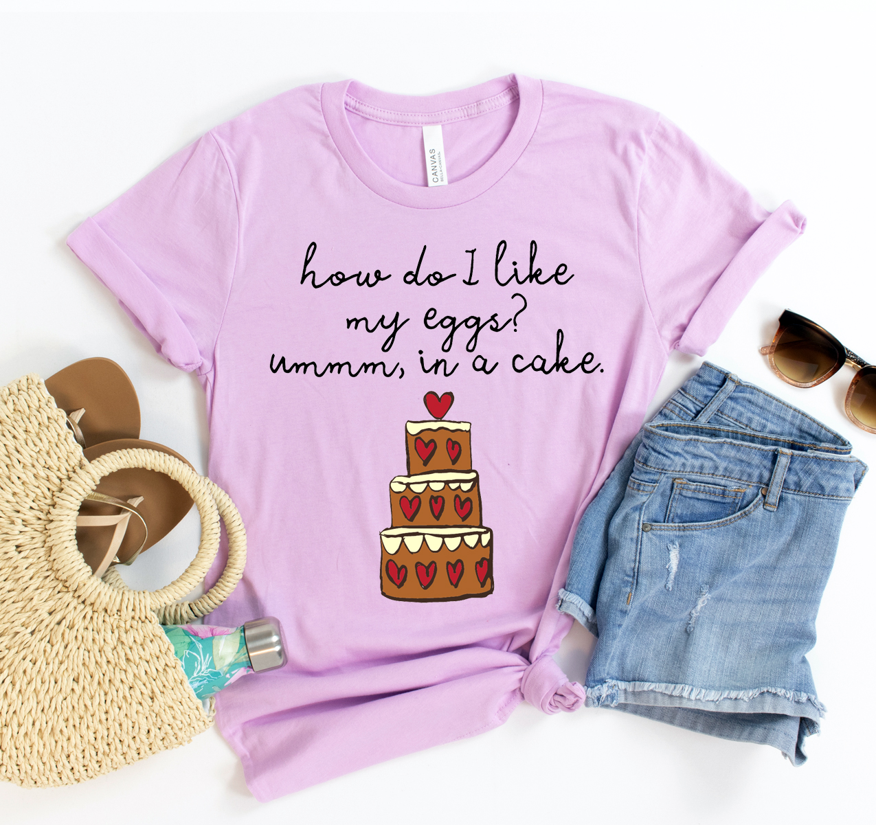A unisex Bella Canvas t-shirt featuring the phrase 'How Do I Like My Eggs Ummm In A Cake' in a playful font, showcasing its soft fabric and casual style.