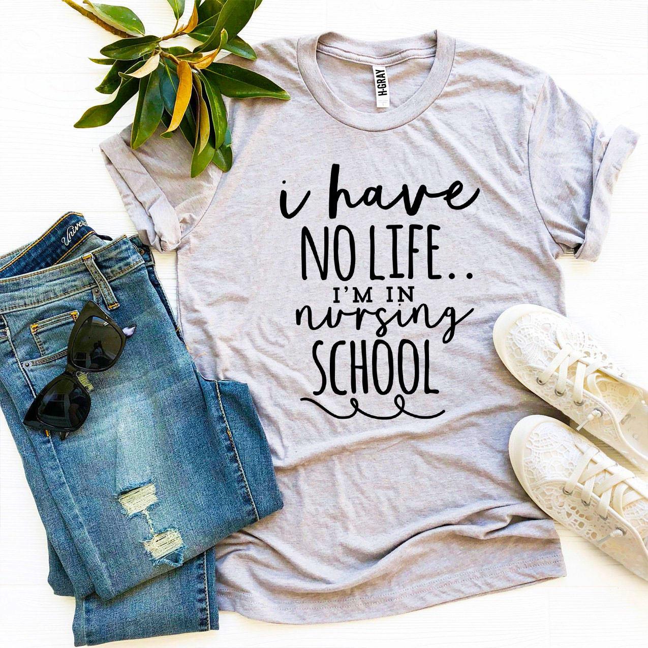 A stylish black T-shirt with the phrase 'I Have No Life I'm In Nursing School' printed in bold white letters, showcasing a comfortable fit.