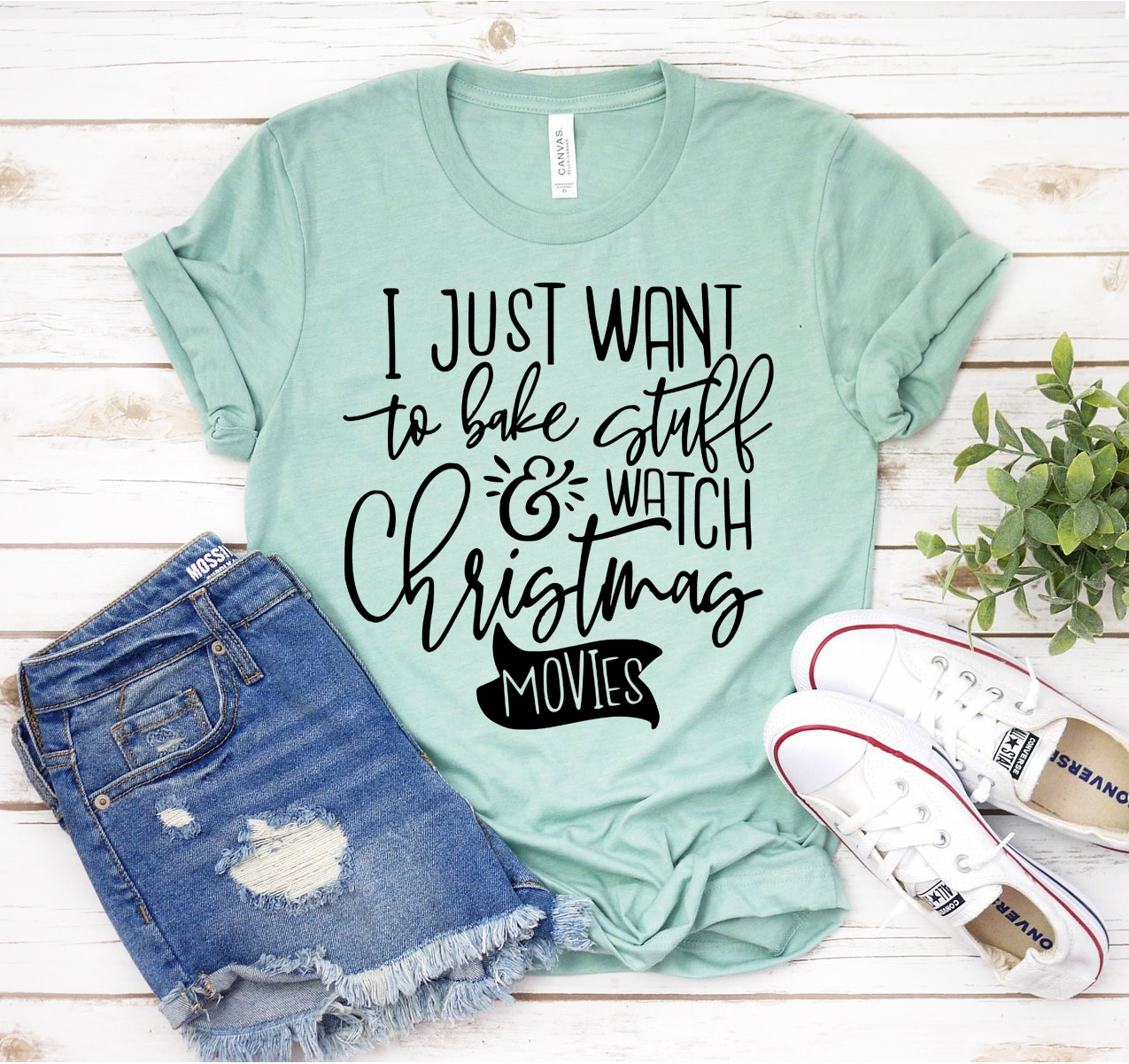 A cozy unisex T-shirt featuring the phrase 'I Just Want To Bake Stuff & Watch Christmas Movies' in festive lettering, perfect for holiday celebrations.