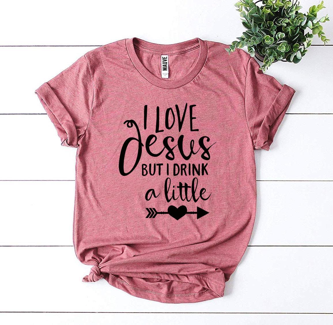 I Love Jesus But I Drink a Little T-shirt made from premium ring spun cotton, featuring a playful design and comfortable fit.