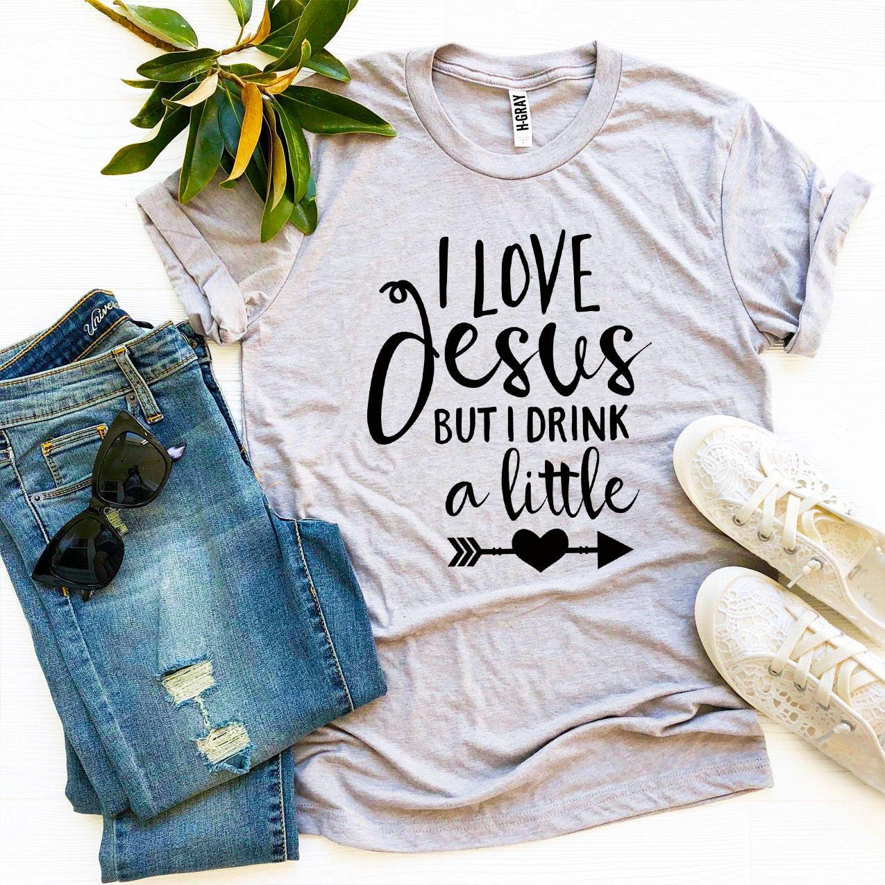 I Love Jesus But I Drink a Little T-shirt made from premium ring spun cotton, featuring a playful design and comfortable fit.