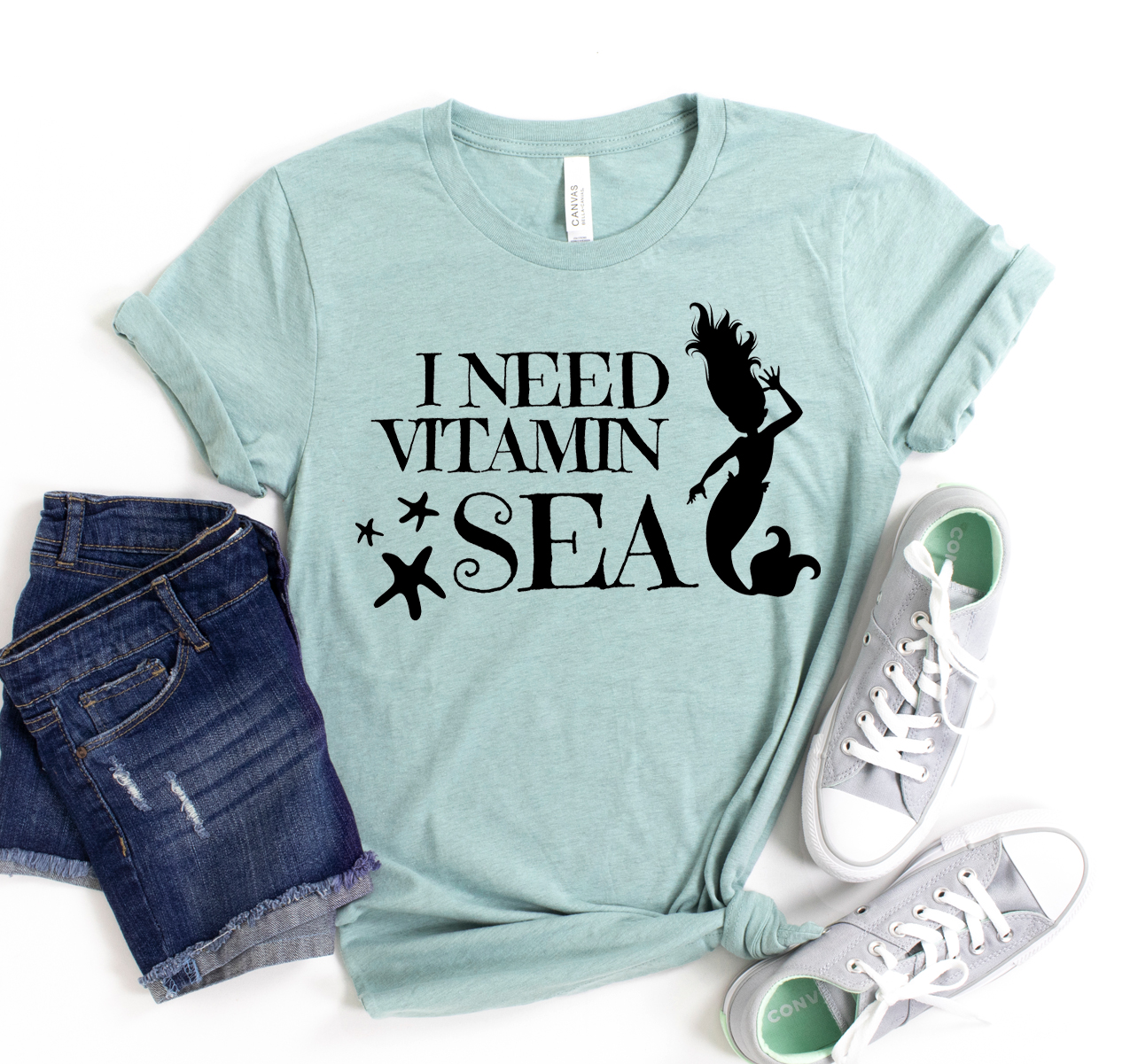 A stylish unisex 'I Need Vitamin Sea' T-shirt displayed on a hanger, showcasing its soft fabric and vibrant print.