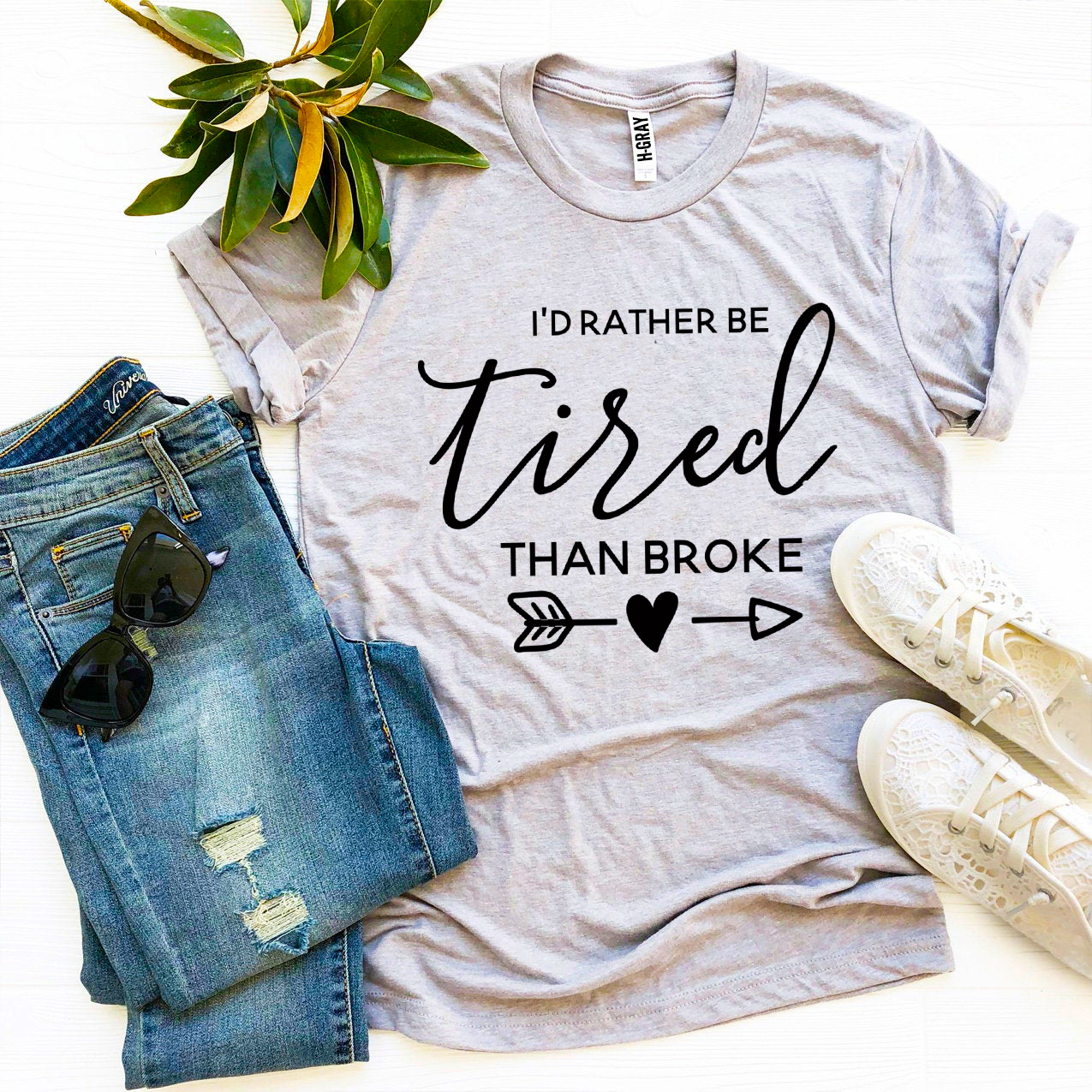 I’d Rather Be Tired Than Broke T-shirt in premium ring spun cotton, featuring a motivational print and available in various sizes.