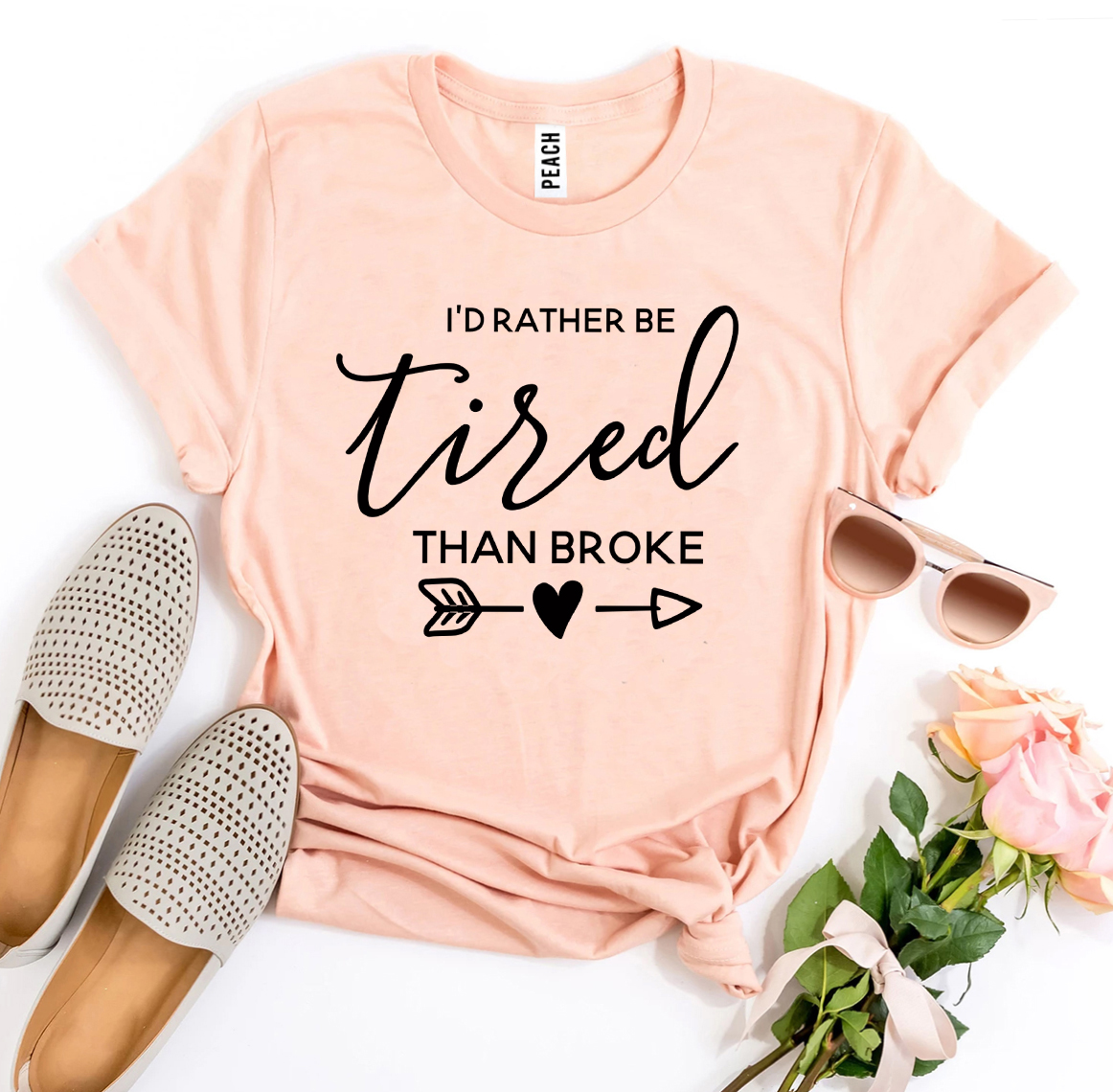 I’d Rather Be Tired Than Broke T-shirt in premium ring spun cotton, featuring a motivational print and available in various sizes.