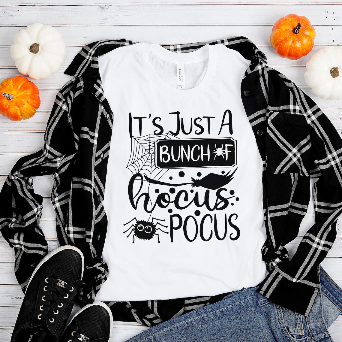 A stylish Halloween T-shirt featuring 'It's Just A Bunch Of Hocus Pocus' design, made from premium ring spun cotton.