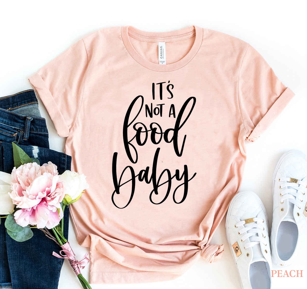 A humorous 'It's not a food baby' T-shirt made from premium ring spun cotton, showcasing a soft feel and high-quality print.