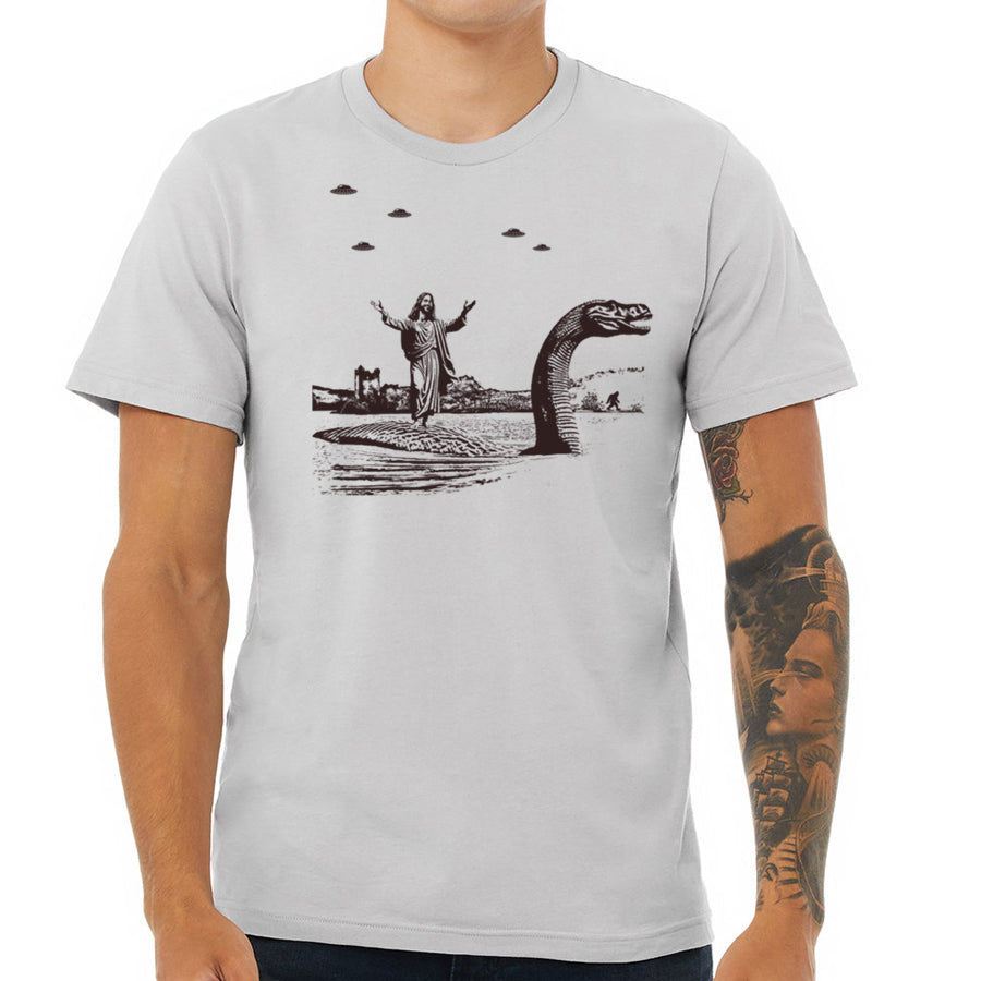 Men's T-shirt featuring Jesus Christ riding the Loch Ness Monster, hand printed with eco-friendly ink.