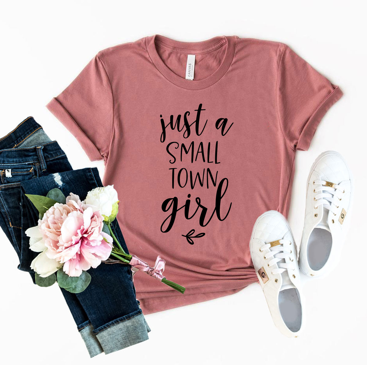 A stylish unisex T-shirt featuring the phrase 'Just A Small Town Girl', made from soft ring spun cotton, available in multiple colors.