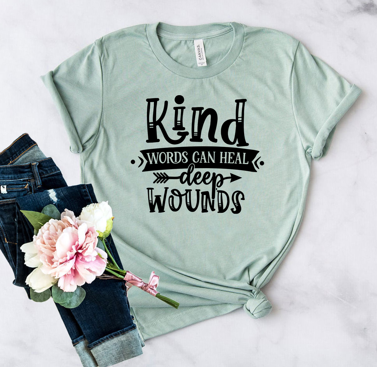 Unisex T-shirt featuring the phrase 'Kind Words Can Heal Deep Wounds' in a stylish design, available in multiple colors.