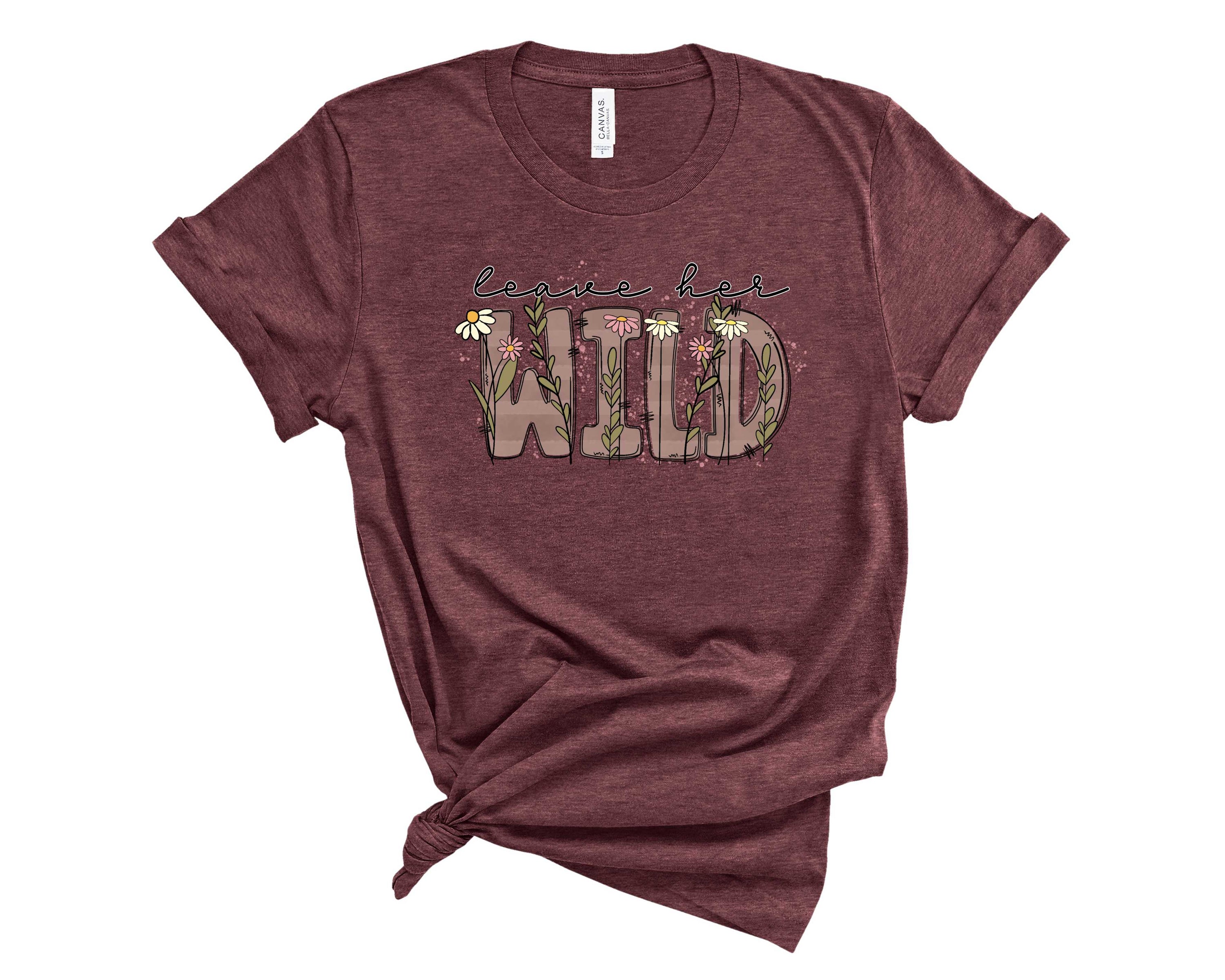 Leave Her Wild Graphic Tee featuring a bold design on a soft fabric, suitable for all genders.