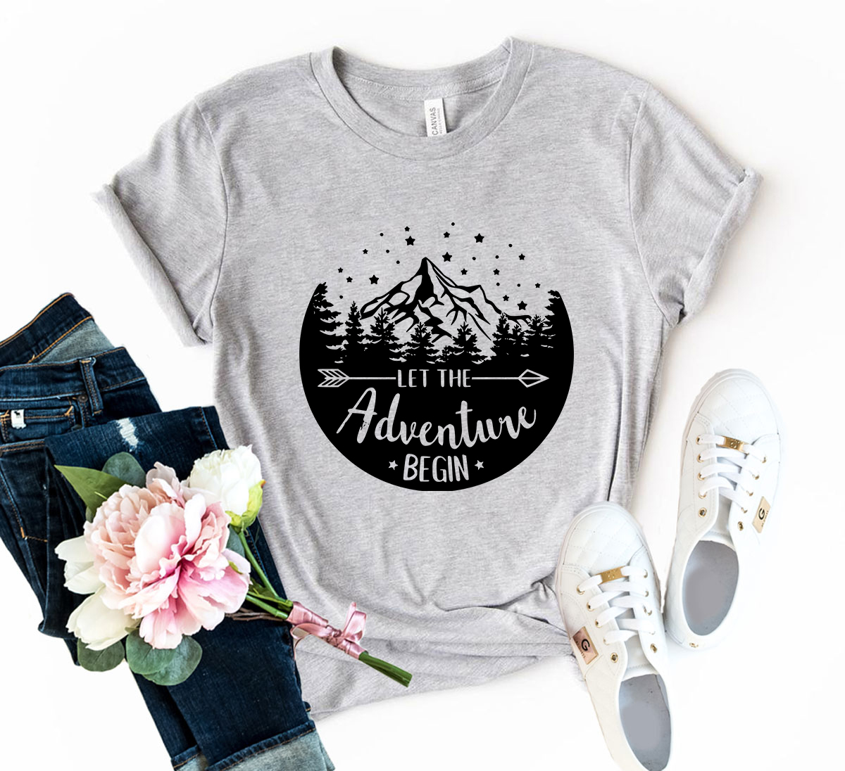 Unisex Let The Adventure Begin Shirt in various colors, showcasing its soft fabric and stylish design.