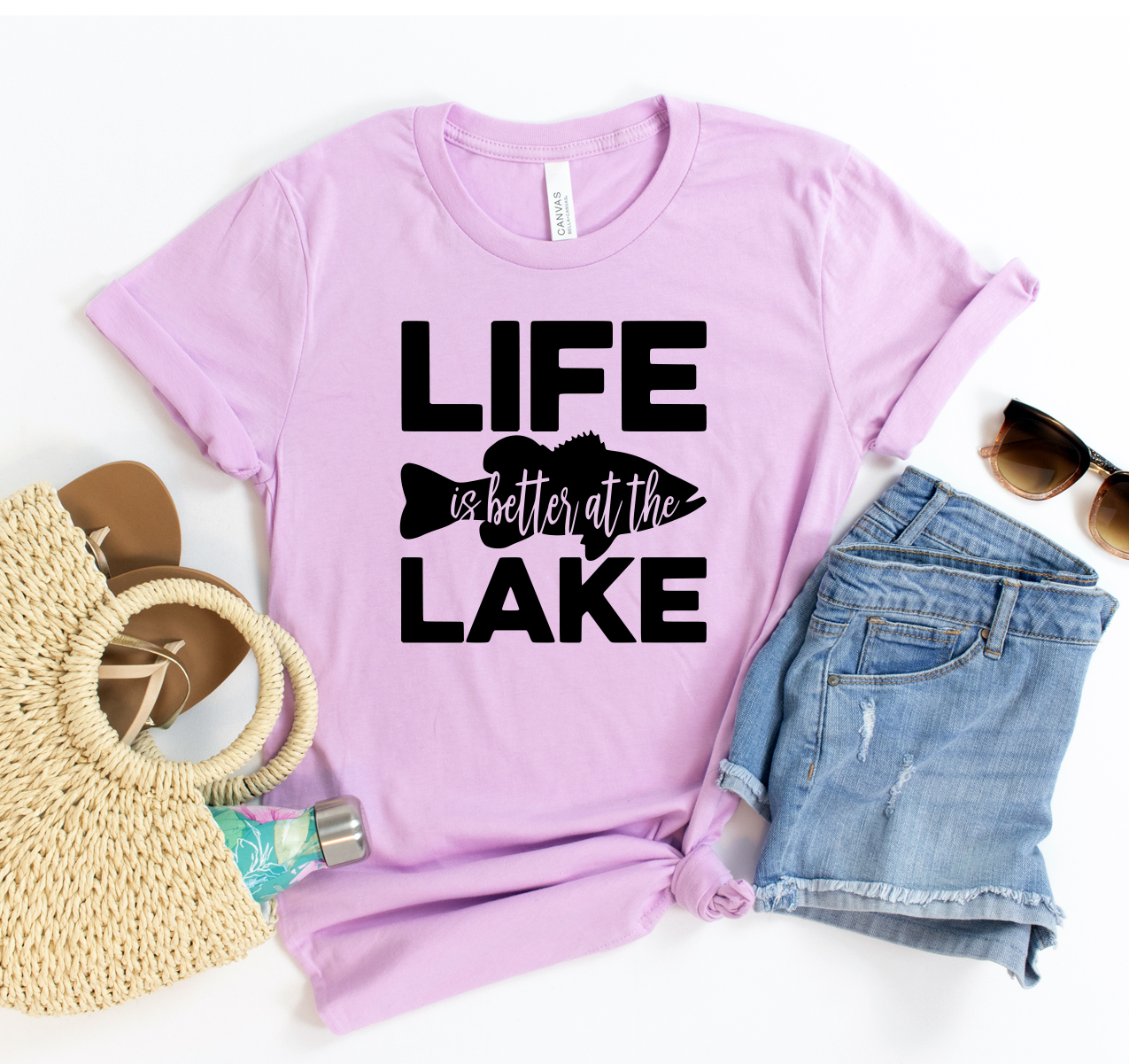 A unisex 'Life is Better At The Lake' T-shirt displayed on a hanger, showcasing its soft fabric and vibrant print.