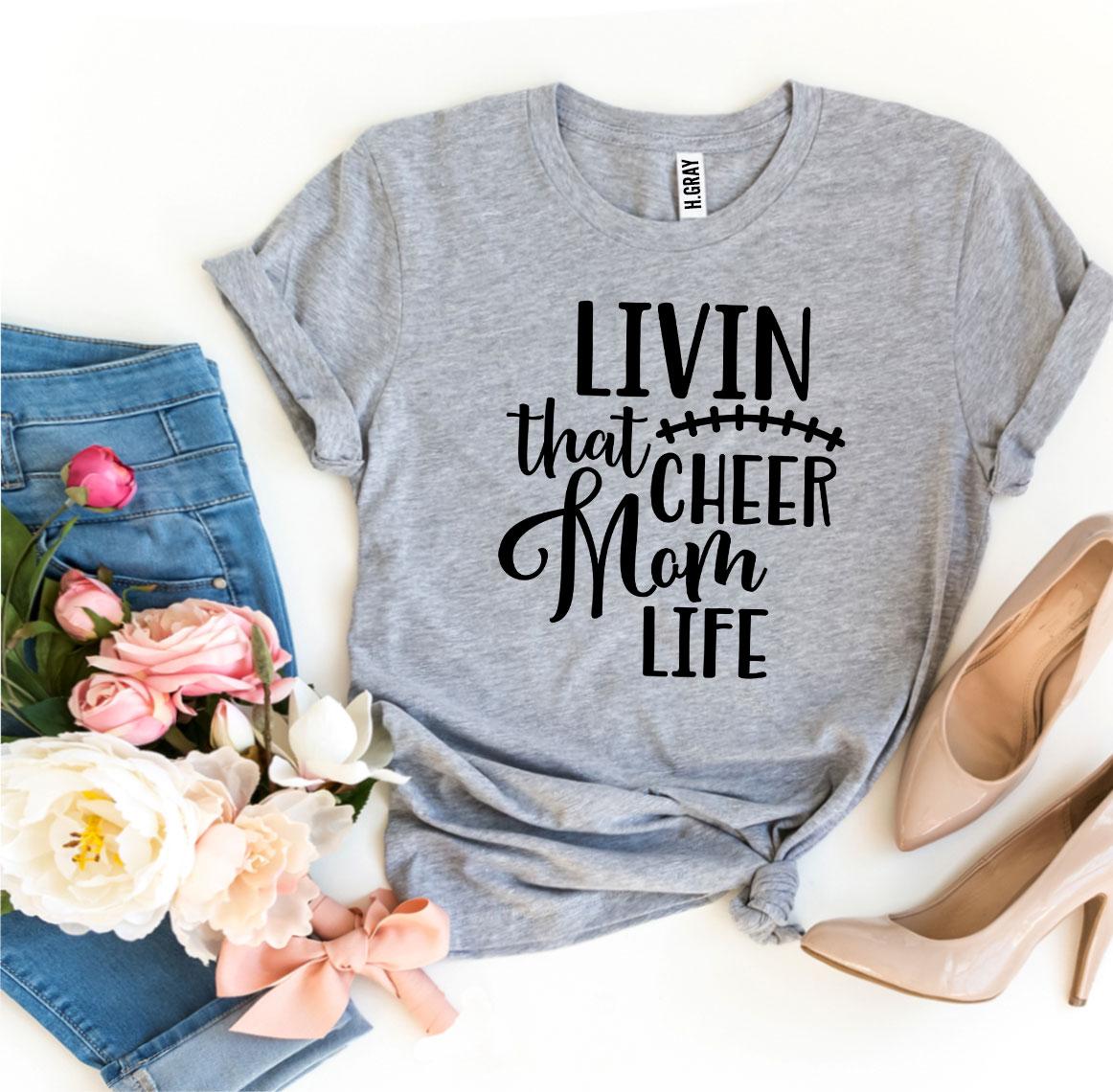 Livin That Cheer Mom Life T-shirt in premium ring spun cotton with a stylish design, available in multiple sizes.
